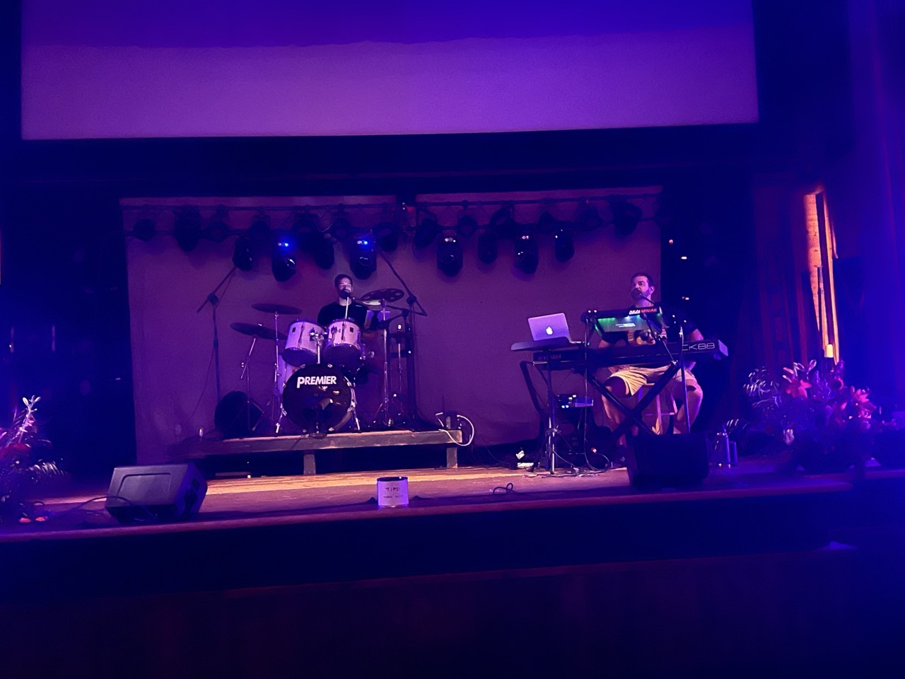 Hot Popsicle performing as a duo on a lit theater stage